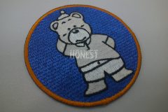 青色の生地にクマのキャラクターを刺繡した、オリジナル刺繡ワッペンの制作実績。