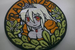 オレンジ色の生地をベースにキャラクター刺しゅうを中心部に配したオリジナル刺繍ワッペンの制作実績。