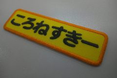 山吹色のツイル生地をベースに黒糸で文字を刺繍。外周フチは濃いめのオレンジで生成したもったいないワッペン。