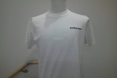 白のTシャツの左胸に黒糸で会社名ロゴをオリジナル刺繍加工した作品を正面から映した作品実績。