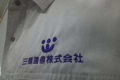 作業服の左胸に企業ロゴと社名を二段で加工した、オリジナル刺繍の制作事例のアップ。