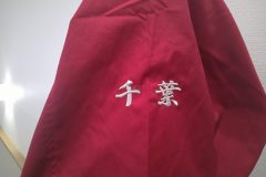 赤のスウィングトップの右袖に県名を銀糸で刺繍した、刺繍屋HONESTの制作事例のアップ。