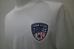 白Tシャツの左胸にサッカーボールが描かれたプリント生地を白糸で縁取り刺繡した制作事例。