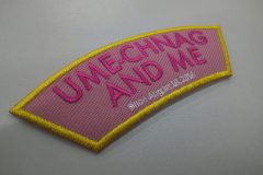 淡いピンク色の布地に周囲を黄色い糸の縁取りを施したオリジナル刺繡ワッペンの制作事例。