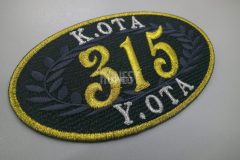 黒地に金色の縁取りと数字が、 誇り・格式・特別感を強く感じさせるオリジナル刺繡ワッペンの制作事例。
