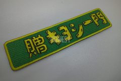 濃い緑色地に黄色い糸で縁取りされた横長の長方形のオリジナル刺繍ワッペンの制作実績。