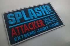 黒地のワッペン。青文字で『SPLASH TOUR』、赤文字で『ATTACKER 2016–2017』、下部に青文字で『EXTREME JOINT GAME』が刺繍されたサバイバルゲームの記念オリジナル刺繡ワッペンの制作見本。