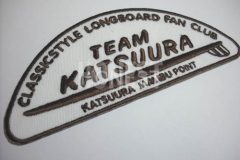 アイボリーカラーのツイル生地を土台にフィッシングチームのロゴをこげ茶色の糸で刺繍した、オリジナル刺繍ワッペンの制作事例。