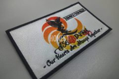 オレンジのグラデーションが綺麗な昇華転写プリントと刺繡を組み合わせた、ミックスワッペンの制作事例。