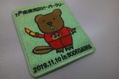 ビーバーが五輪のマークが描かれたセットアップを着てトーチを掲げているデザインのオリジナル刺繡ワッペンの制作実績。
