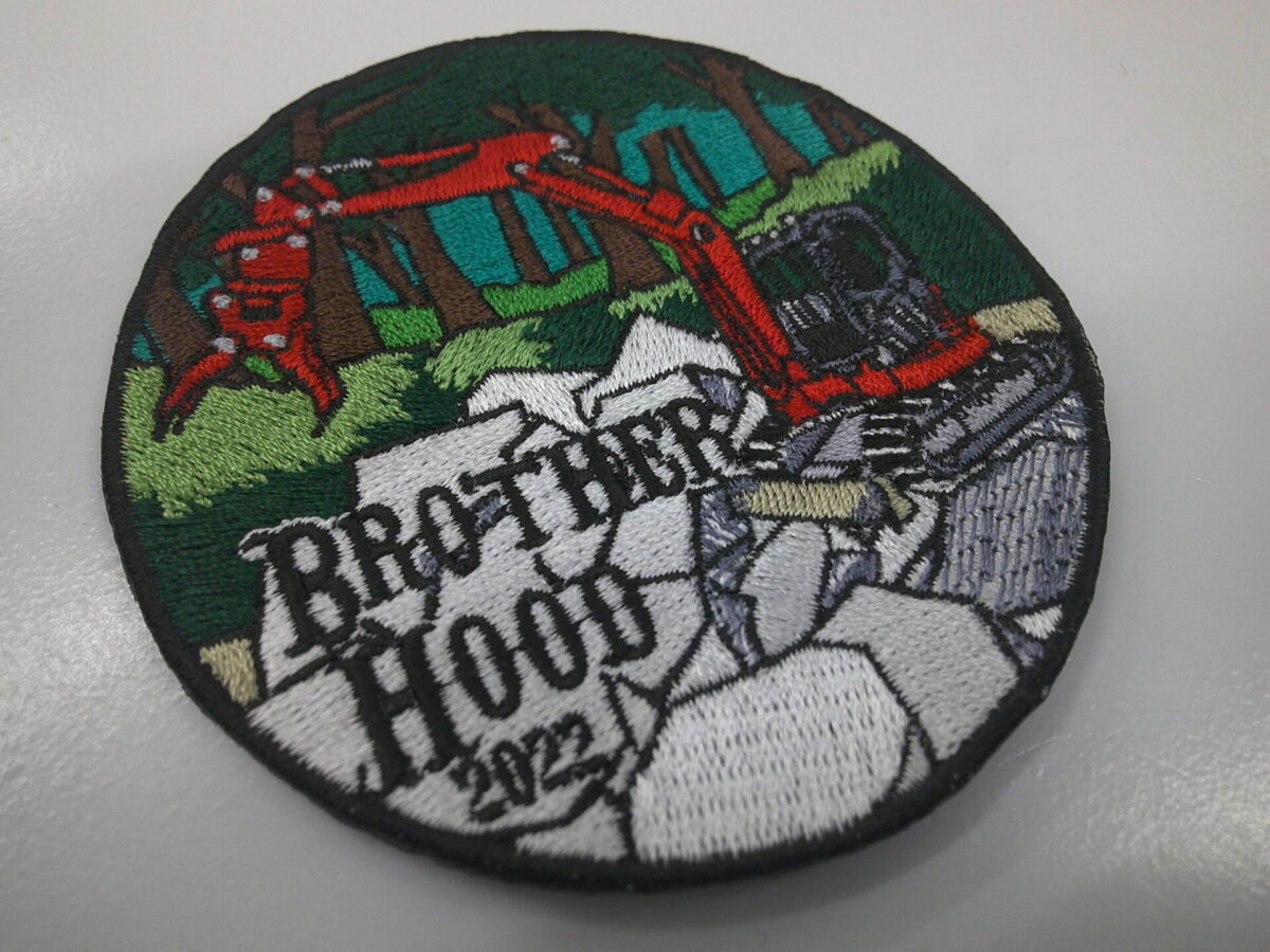 ショベルカーで災害復旧工事をしているデザインのオリジナル刺繍ワッペンの制作実績。